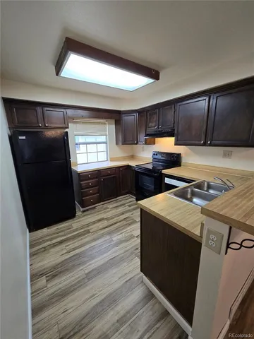 a kitchen with a stove and a refrigerator