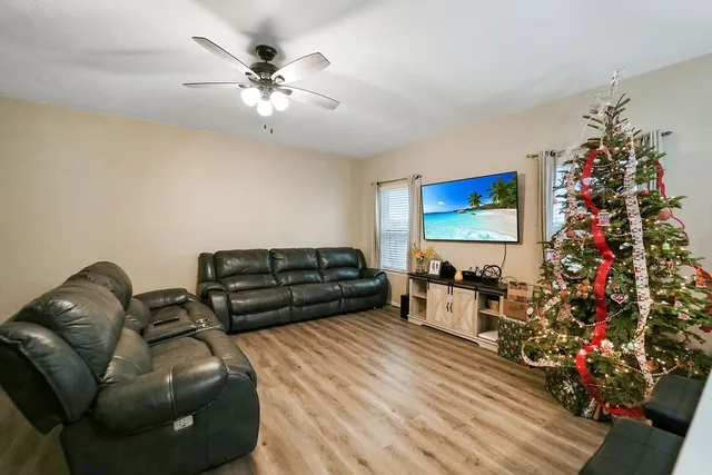 a living room with furniture and flowers