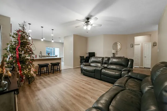 a living room with furniture flower pot and a table
