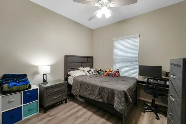 a bedroom with a bed and a chandelier