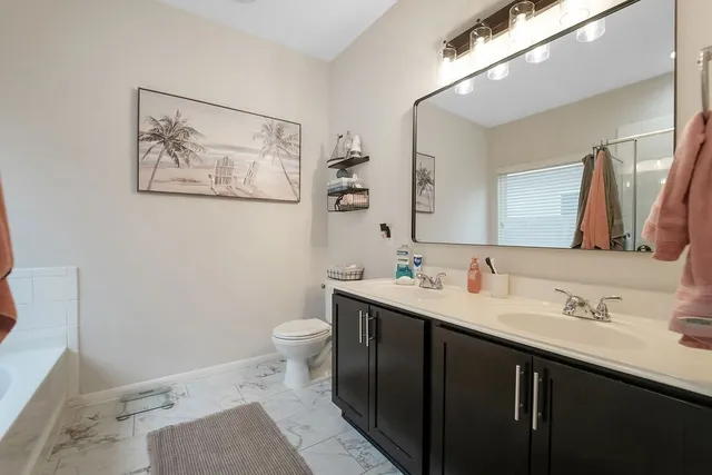 a bathroom with a toilet sink and mirror