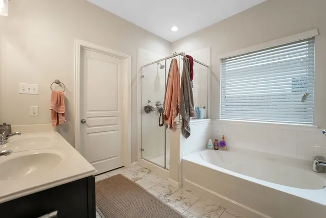 a bathroom with a tub sink and a shower