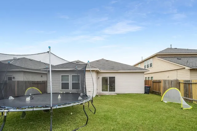 a view of a house with backyard and sitting area