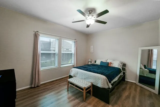 a bedroom with a large bed and a window