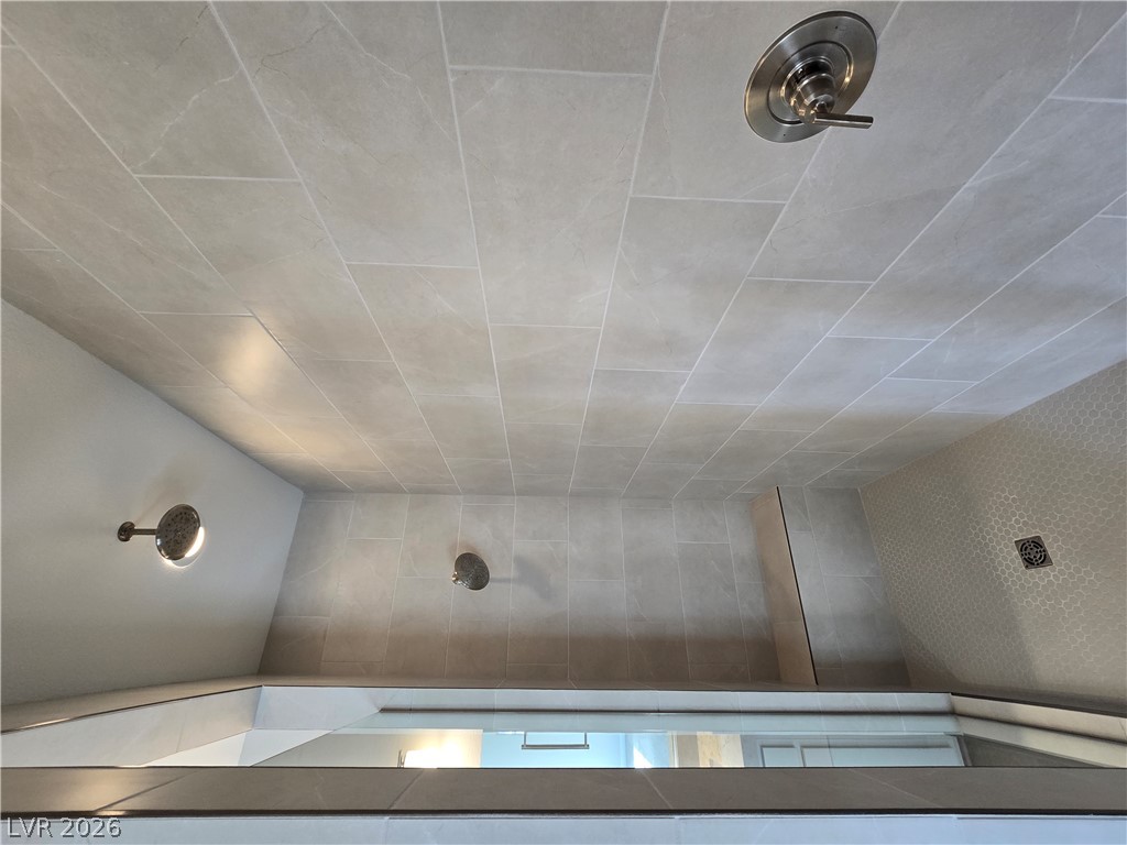 852 Weston Ridge Street Henderson, NV 89011 - Photo 20 of 28 Indulge in this contemporary tiled shower featuring multiple showerheads and seamless glass enclosure.