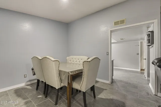 a view of a room with furniture and wooden floor