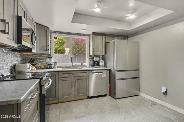 a kitchen with a refrigerator sink and stove