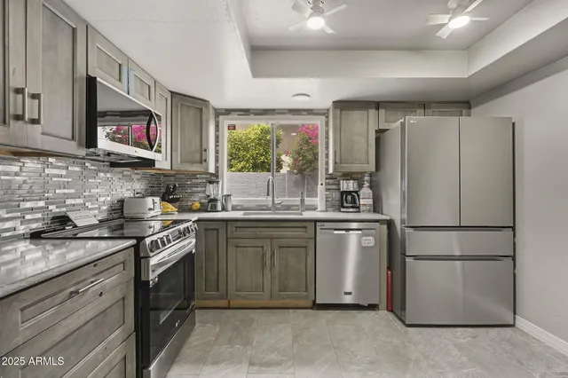 a kitchen with a refrigerator stove and sink