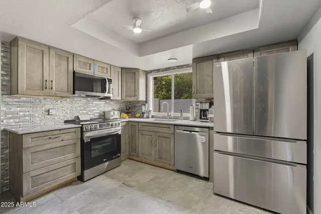 a kitchen with a refrigerator stove and sink