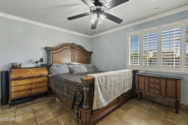 a bedroom with a bed and a ceiling fan