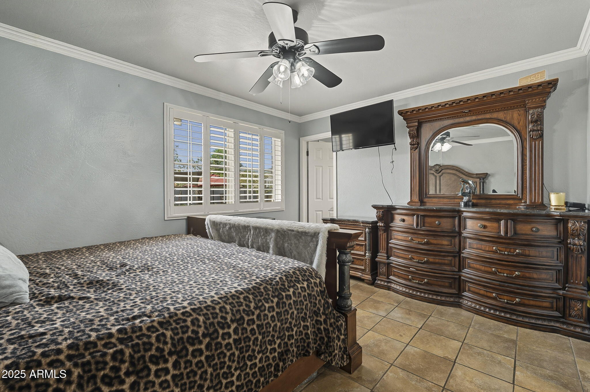 2103 West Palomino Drive Chandler, AZ 85224 - Photo 20 of 46 a bedroom with a bed and a chandelier