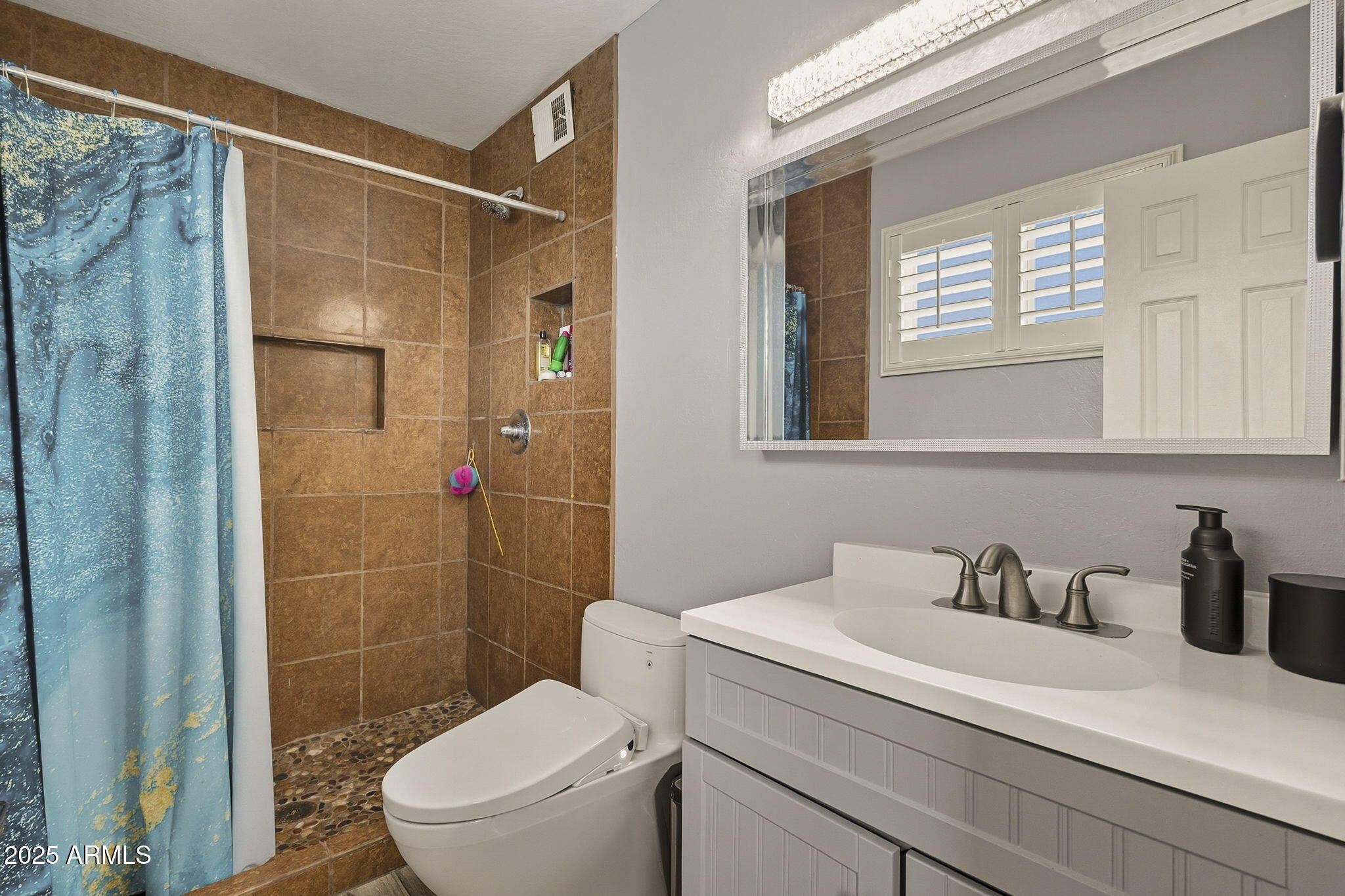 2103 West Palomino Drive Chandler, AZ 85224 - Photo 22 of 46 a bathroom with a sink a toilet and shower
