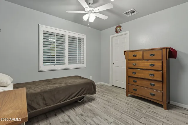 a bedroom with a bed and a dresser
