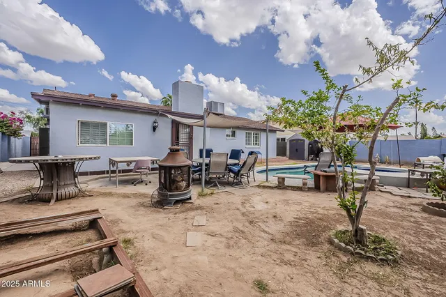 a view of a backyard with sitting area