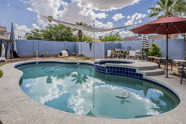 a view of a swimming pool with a patio