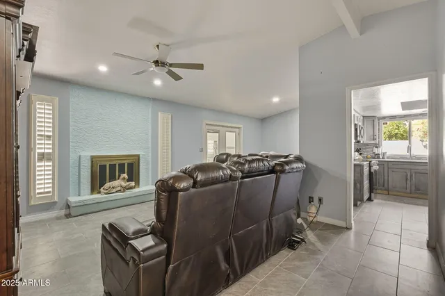 a living room with furniture a fireplace and a flat screen tv