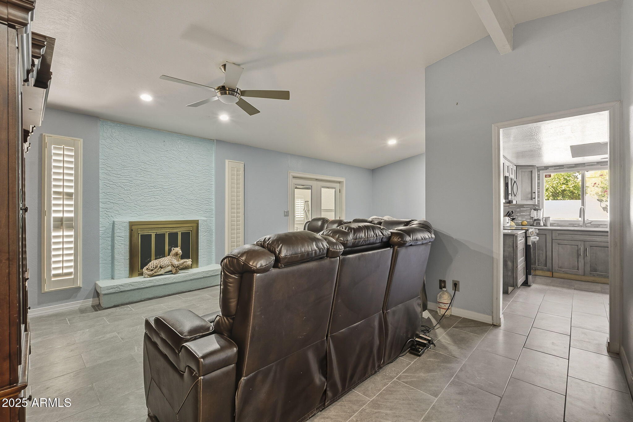 2103 West Palomino Drive Chandler, AZ 85224 - Photo 6 of 46 a living room with furniture a fireplace and a flat screen tv