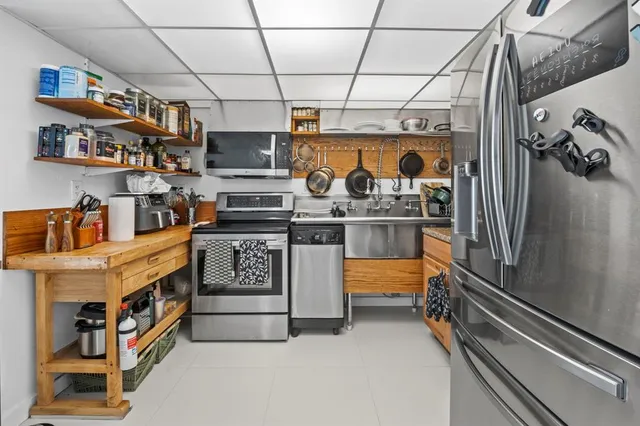 a kitchen with stainless steel appliances granite countertop a stove and a refrigerator