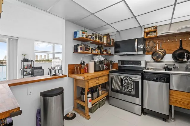 a kitchen with stainless steel appliances granite countertop a stove and a sink