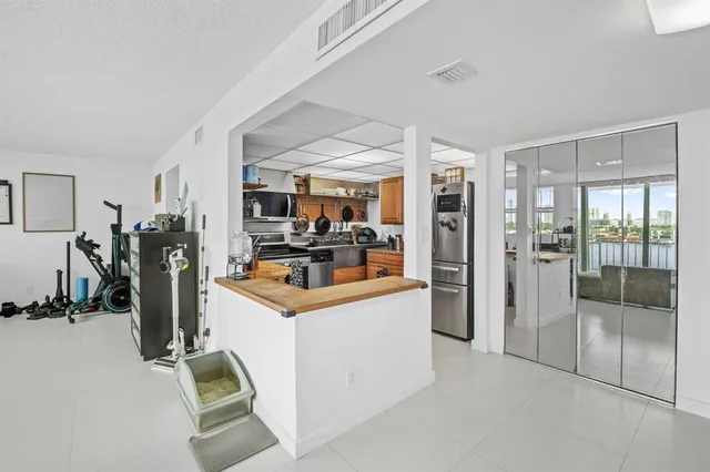 a view of a living room kitchen and a refrigerator