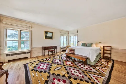 a bedroom with furniture and a window