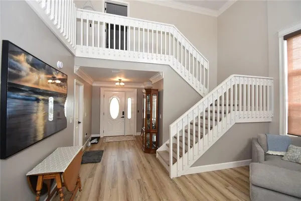 a view of staircase with white walls and wooden floor