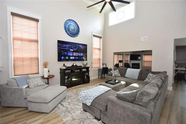 a large bedroom with a bed mirror and window