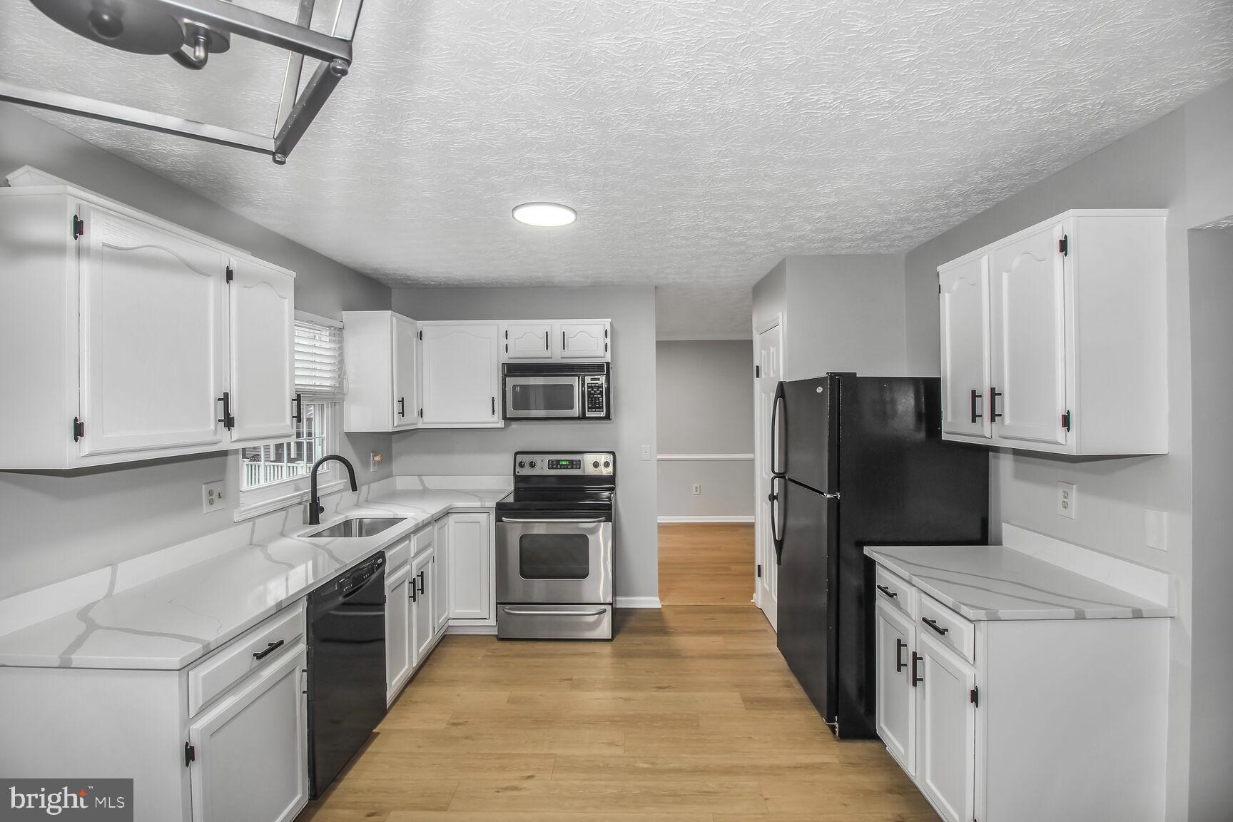 408 Sutton Place Abingdon, MD 21009 - Photo 10 of 26 a kitchen with stainless steel appliances granite countertop a refrigerator a stove top oven a sink and dishwasher