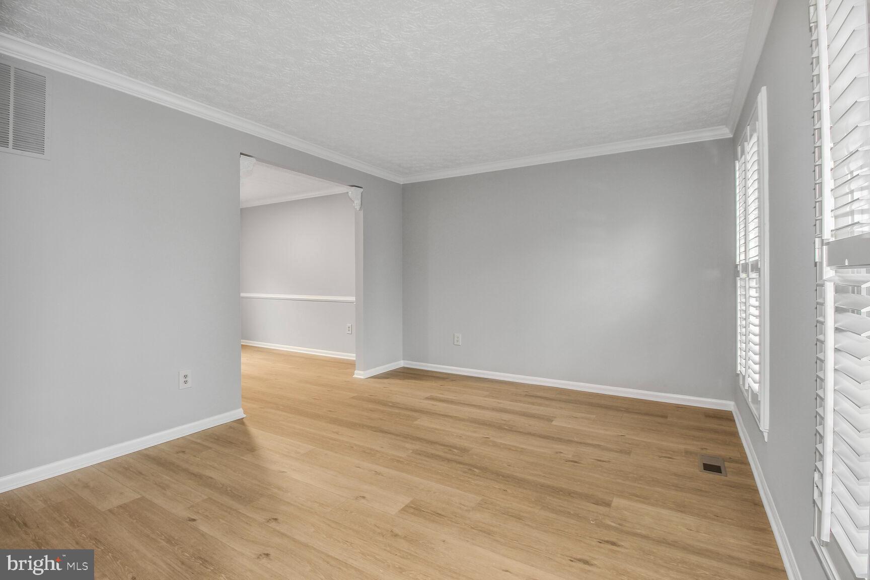 408 Sutton Place Abingdon, MD 21009 - Photo 4 of 26 a view of an empty room with wooden floor and a window