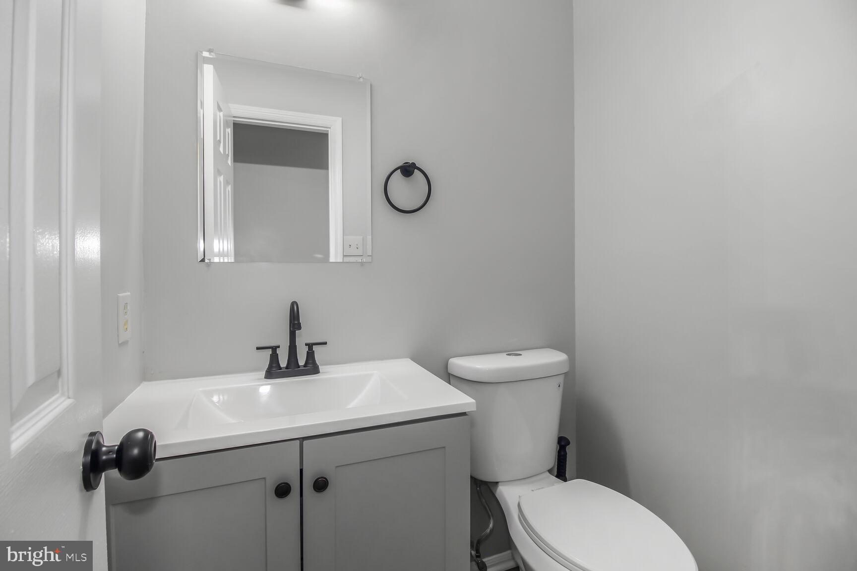 408 Sutton Place Abingdon, MD 21009 - Photo 7 of 26 a bathroom with a toilet a sink and mirror