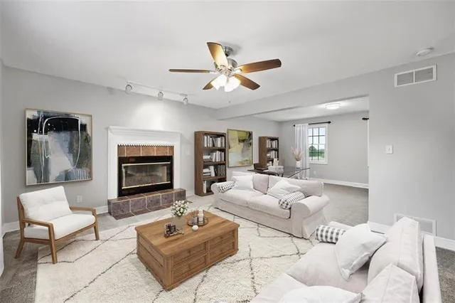 a living room with furniture and a fireplace