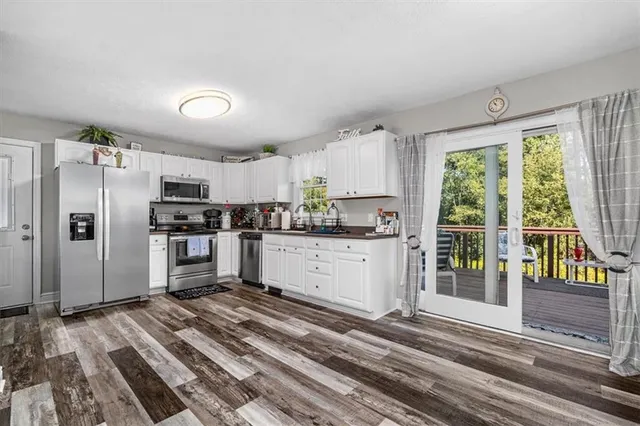 a kitchen with stainless steel appliances a refrigerator and a stove top oven