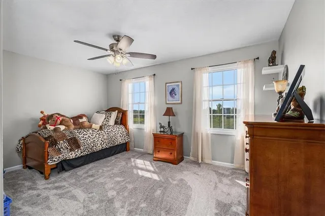 a bedroom with bed and window