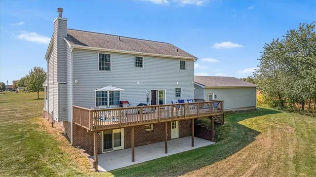 a view of a house with backyard and sitting area
