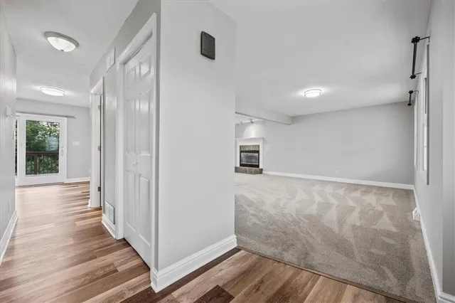a view of a hallway with wooden floor and staircase