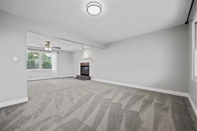 an empty room with windows and cabinet