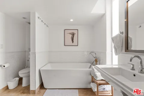 a white bath tub sitting next to a white toilet