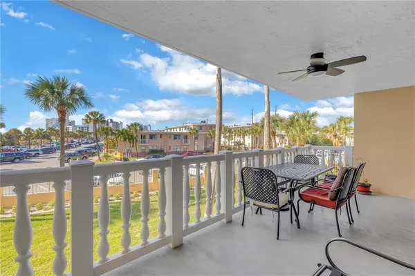 a view of a chairs and table in patio with a lake view