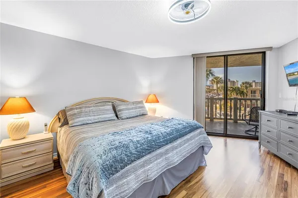 a bedroom with a bed and large window