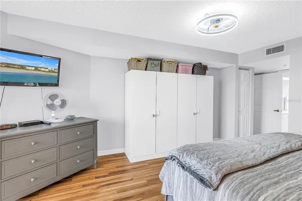 a bedroom with a bed and a dresser in it