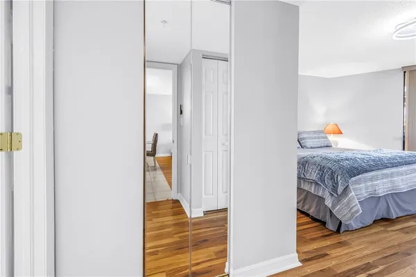 a bedroom with a bed and wooden floor