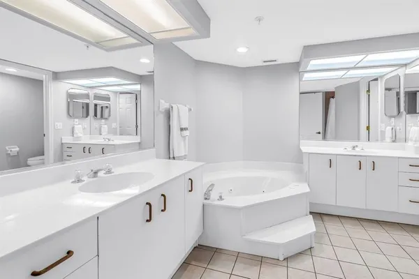 a bathroom with a sink mirror and a bathtub