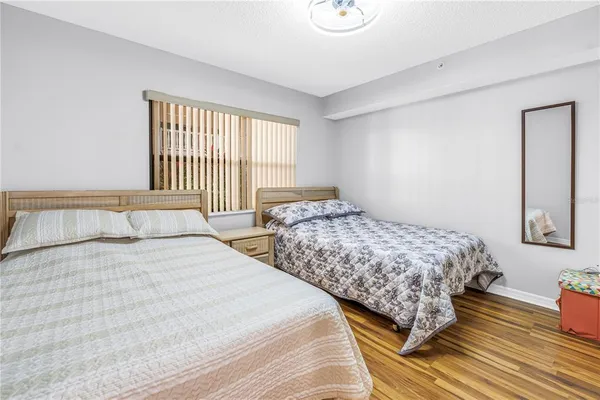 a bedroom with two beds and a window