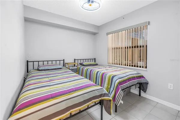 a bedroom with bed and a window