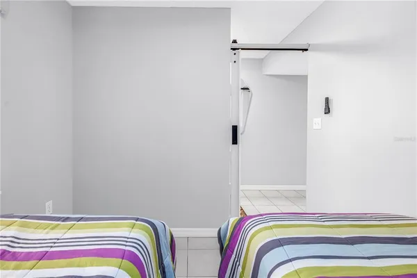 a bedroom with a bed and a painting on the wall