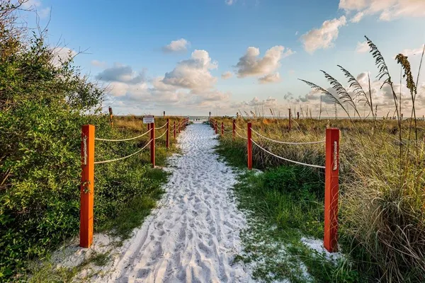 a view of a pathway with a wrought fence