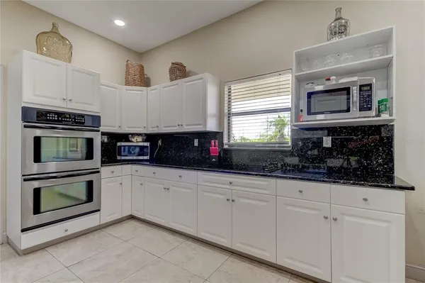 a kitchen with stainless steel appliances granite countertop a sink and a stove