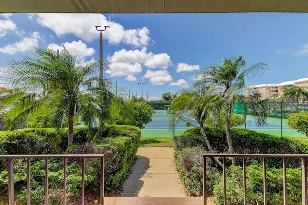 a view of a pathway of a house next to a yard