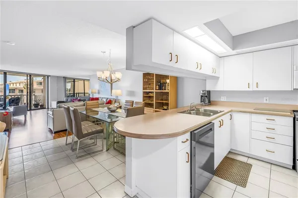 a kitchen with cabinets and chairs
