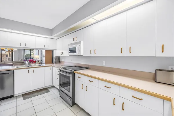 a kitchen with cabinets and appliances